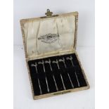 A set of six HM silver cocktail sticks having cockerel terminals within original Reed and Sons