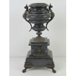 A Victorian slate architectural garniture having urn over decorated with mythical winged beasts ,