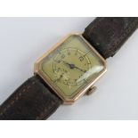 A 9ct gold Art Deco tank watch hallmarked for 1936 having gilded dial with subsidiary seconds dial