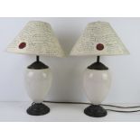 A pair of Laura Ashley ceramic table lamps with Laura Ashley paper shades.