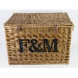 A large coffee table sized Fortnum & Masons wicker hamper, 57 x 40 x 40cm.