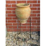A terracotta urn shaped planter in iron frame, 76cm high.