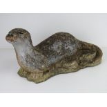 A pre-cast garden statue of an otter, approx 55cm in length.