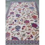 A Society Tappeti Italian cotton rug with floral design on cream ground,