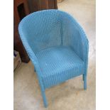 An original Lloyd Loom Lusty wicker tub style chair in turquoise blue having original label upon.