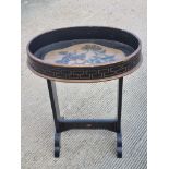 A hand painted and ebonised oval occasional table, 50 x 32cm approx.