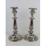 A pair of silver plated candlesticks having profuse repoussé decoration throughout and removable