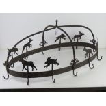 A wrought iron farmhouse style kitchen utensils hanger decorated with deer and rabbits,