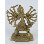 A brass South Asian many armed deity figurine standing approx 25cm high.