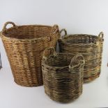 A pair of graduated wicker baskets together with a similar, larger wicker basket.