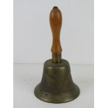 A brass hand bell marked Fiddian having turned wooden handle.