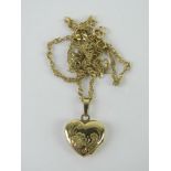 A 9ct gold heart shaped locket on a 9ct gold fancy link chain, 2.3g.