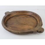 A hand carved wooden tray having lug handles, 53.5cm widest.