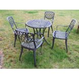 A green painted aluminium bistro table and four chairs.