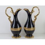 A pair of Limoges cobalt blue ground and 22 carat gold plated ewers each standing 37.