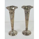 A pair of HM silver bud vases having fluted rims and weighted bases standing 17.5cm high.