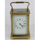 A five glass brass cased carriage clock having swing handle over, with key.