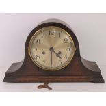 A c1930 oak cased mantel clock with winging key.