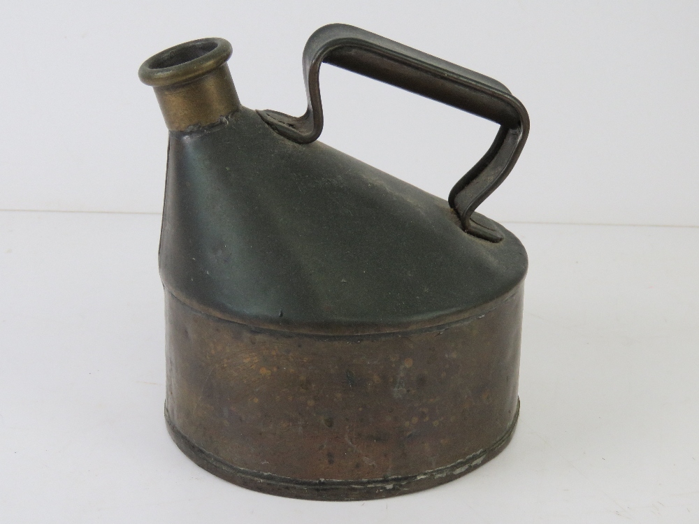 A vintage copper oil can.