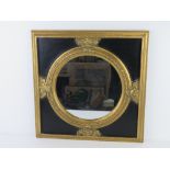 A round wall mirror in black and gold painted contemporary neoclassical style fram 50 x 50cm