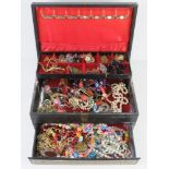 A leatherette jewellery box containing a quantity of assorted costume jewellery.