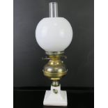 An oil lamp having ceramic base with brass reservoir marked for Duplex,