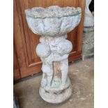 A pre-cast stone planter raised over cherub stand, 58cm high.