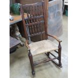 A cane seated fireside chair having later rockers.