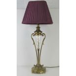 A brass and cut glass table lamp, with purple shade, all standing 72cm high.