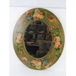 A contemporary oval wall mirror having floral decoration upon 60 x 70cm overall
