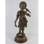A heavy brass figurine of a South Asian goddess with bird on hand standing 51cm high
