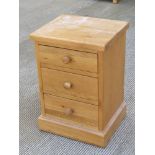 A contemporary oak three drawer bedside table, 38 x 45 x 65cm.