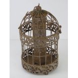 A bird feeder with cage over.