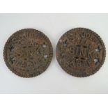 A pair of fireside cast iron pan stands each marked 'saucepan stand for sink or table' each