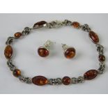 A suite of silver and Baltic amber jewellery being stud earrings and bracelet.