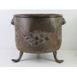 A copper fireside coal bucket having repoussé decoration,