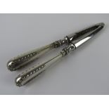 A pair of nut crackers having HM silver handles, London import hallmark.