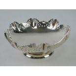 A HM silver bonbon dish having pierced decorative border and raised over single foot,