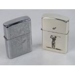 A Zippo lighter, together with a GOlf themed lighter by Hadson. Two items.