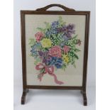 A wool work fire screen depicting bouquet of flowers.