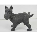 A cast iron doorstop figurine of a dog cocking its leg.