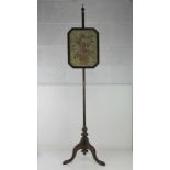 A vintage tapestry pole fire screen having floral basket in glazed octagonal frame, frame 28 x 36cm,