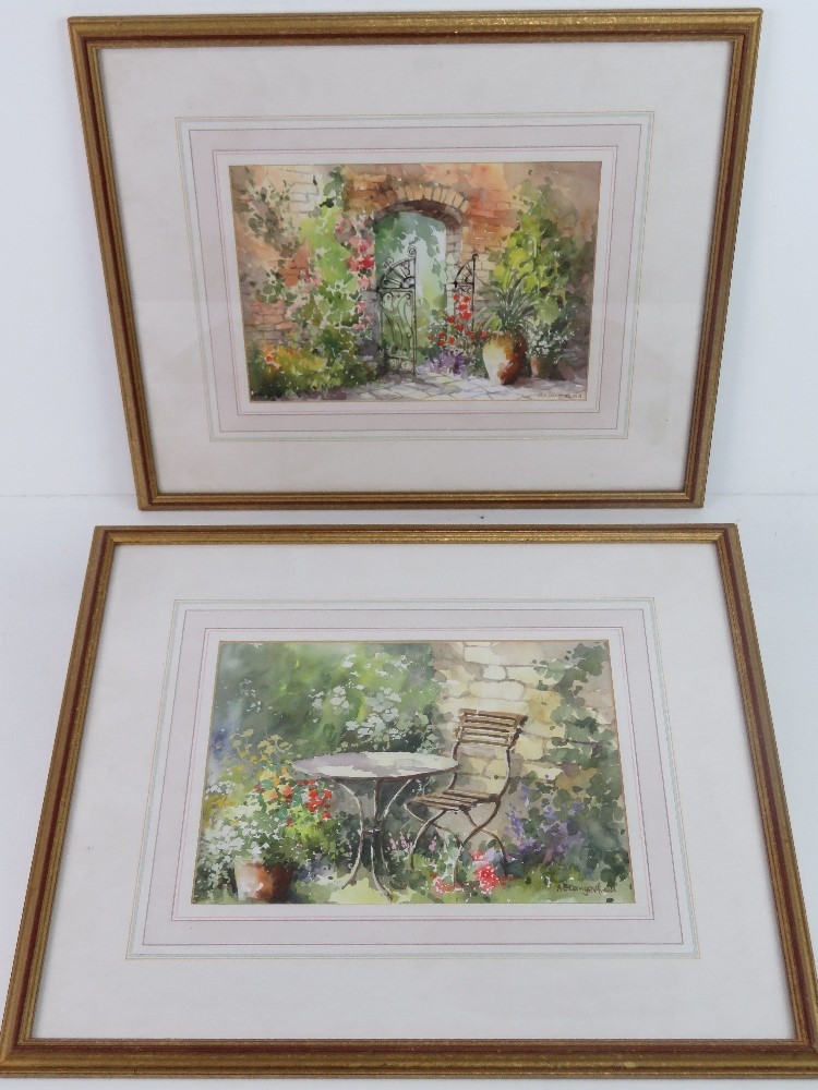 A pair of delightful watercolours, each being a garden scene, framed and mounted.