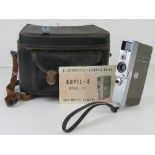 A Kopil-8 Model IC 8mm movie camera with paperwork and case.