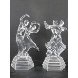 A pair of decorative glass daner figurines.