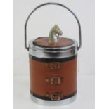 A c1970s ice bucket having leatherette cover with horses head handle and horseshoe design to front.