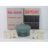 A quantity of decorative kitchen items including cake tin and chalk board signs.