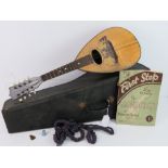A vintage Mandolin in leatherette case, approx 61cm in length.