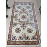 A cream ground rug measuring 164 x 82cm.