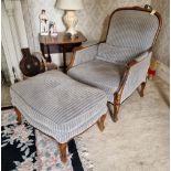 A pair of reproduction wide seat armchairs of Georgian influence with matching footstool.